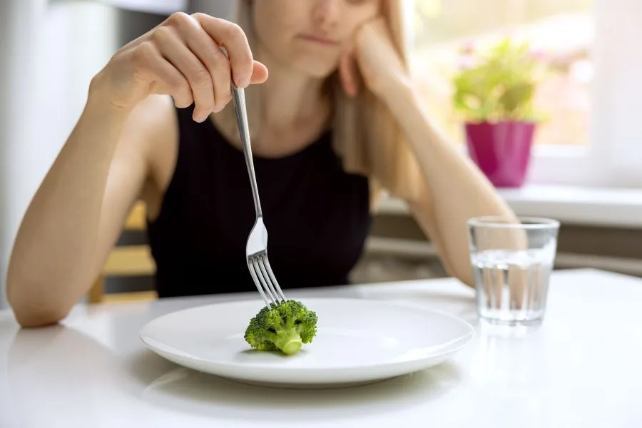 woman with eating disorder restricting herself